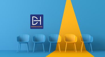 Psychometric assessment expert guiding a diverse team in South Africa through personality and skills testing in a professional office environment