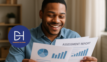 A man smiling while holding and reviewing an assessment report with charts and graphs, featuring the Dominion Holdings logo.